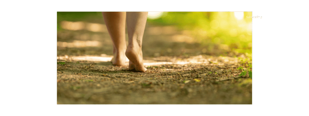bare feet walking on a dirt path